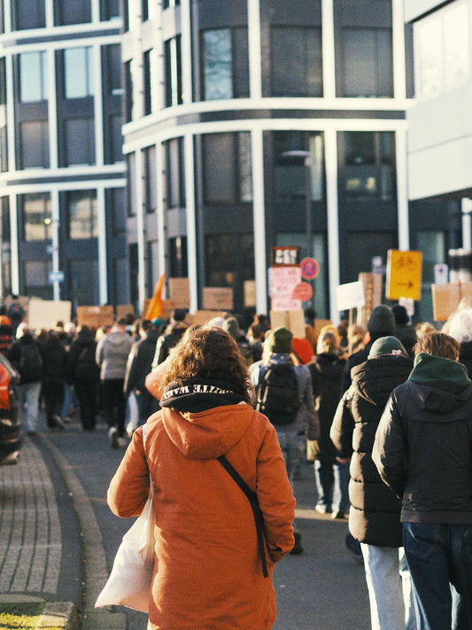 A crowd of people walking down a street